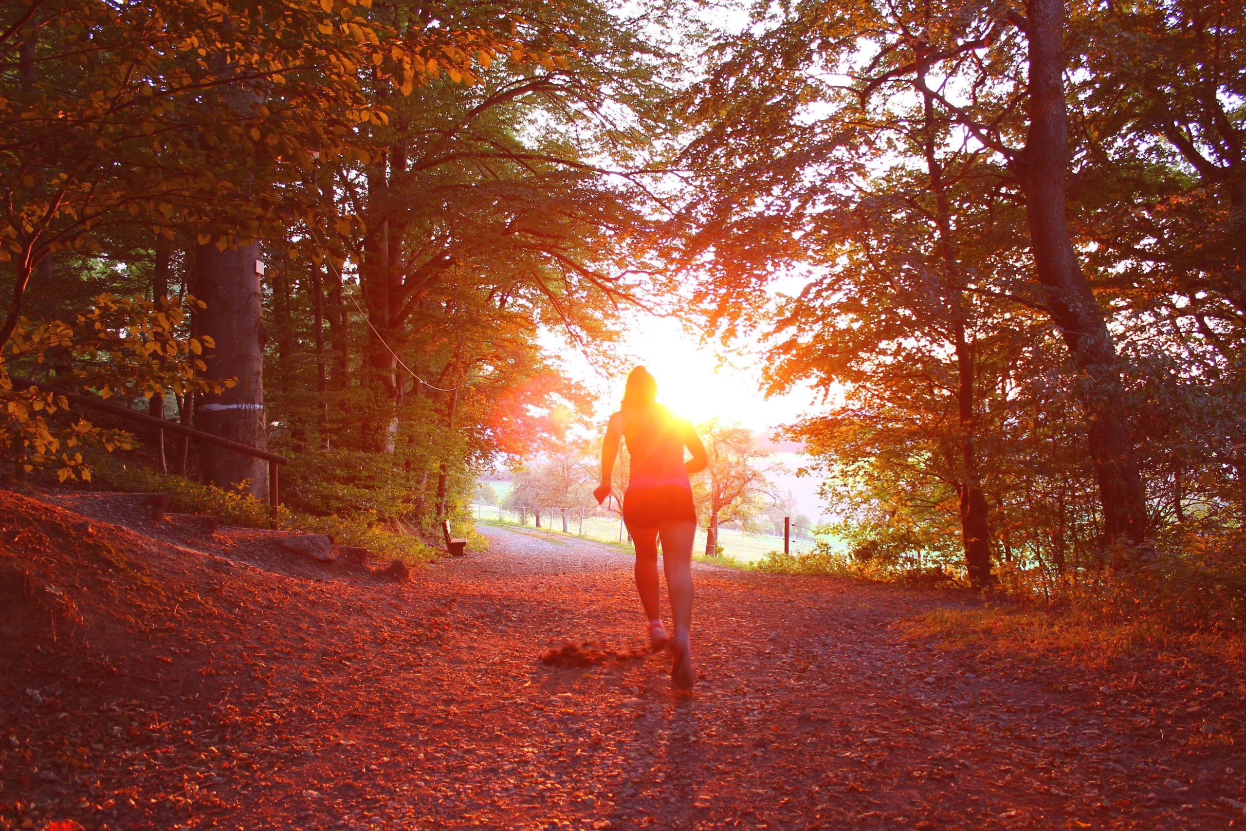 a girl running at sunset