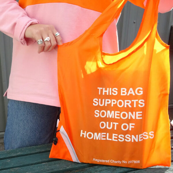 Orange bag with Homeless Oxfordshire slogan | Homeless Oxfordshire shop