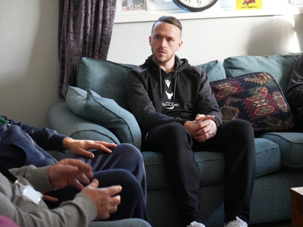 Oxford United Players Listening to Residents at Homeless Oxfordshire's Sapling Project